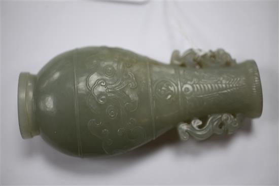 A Chinese celadon jade archaistic flattened pear shape vase, Qianlong / Jiaqing period, 10.9cm